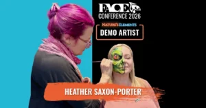 face painter paintin a green skull on a females face
